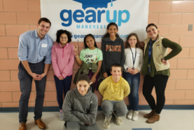 Group of students in front of a GEAR UP banner