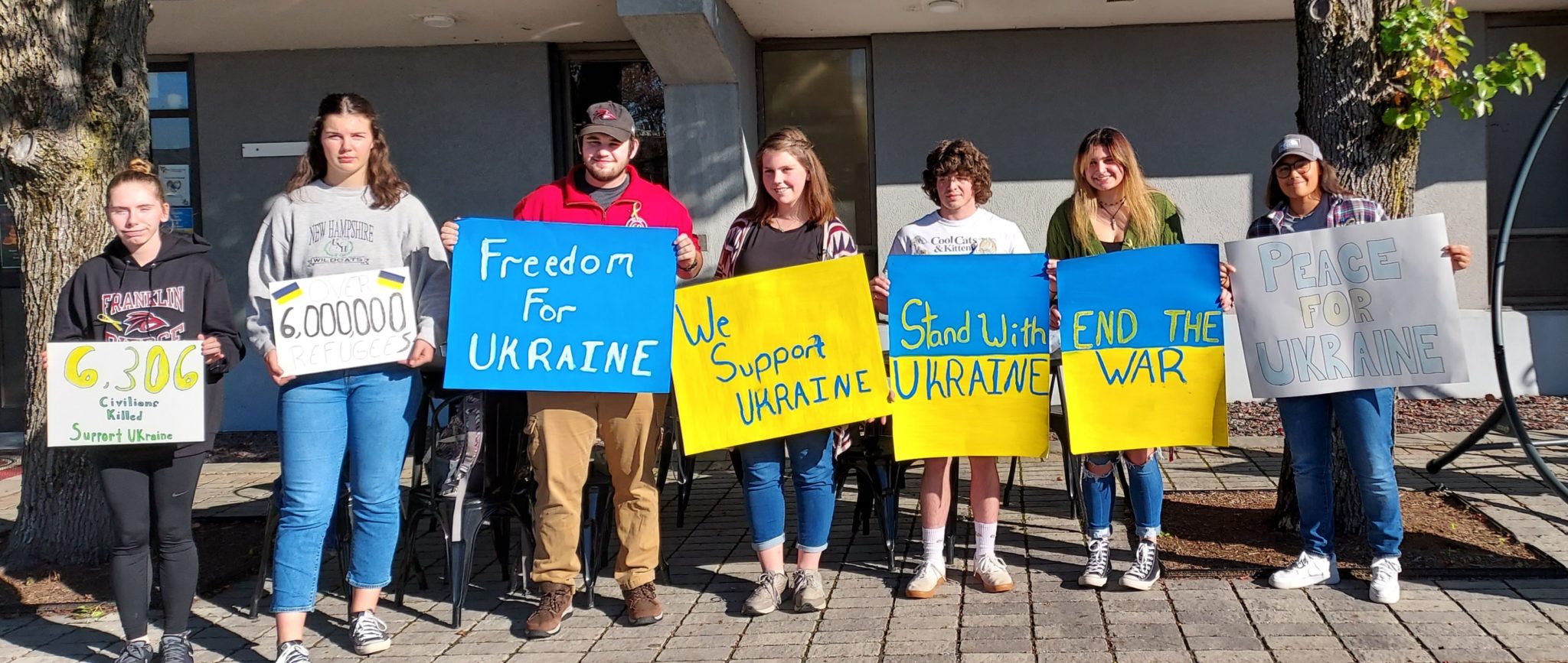 Franklin Pierce University students with signs march in support of Ukraine